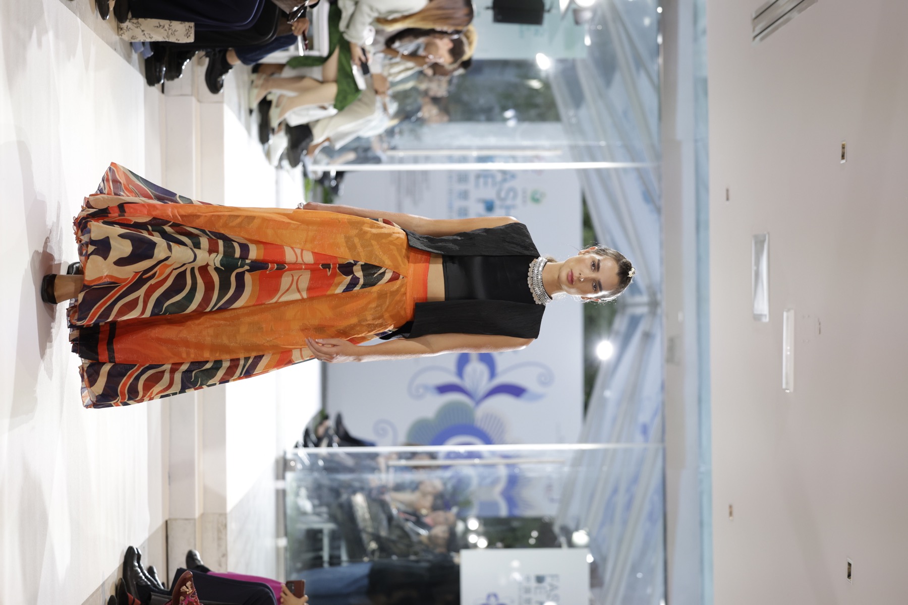 Contemporary orange Chuxiong-inspired runway look